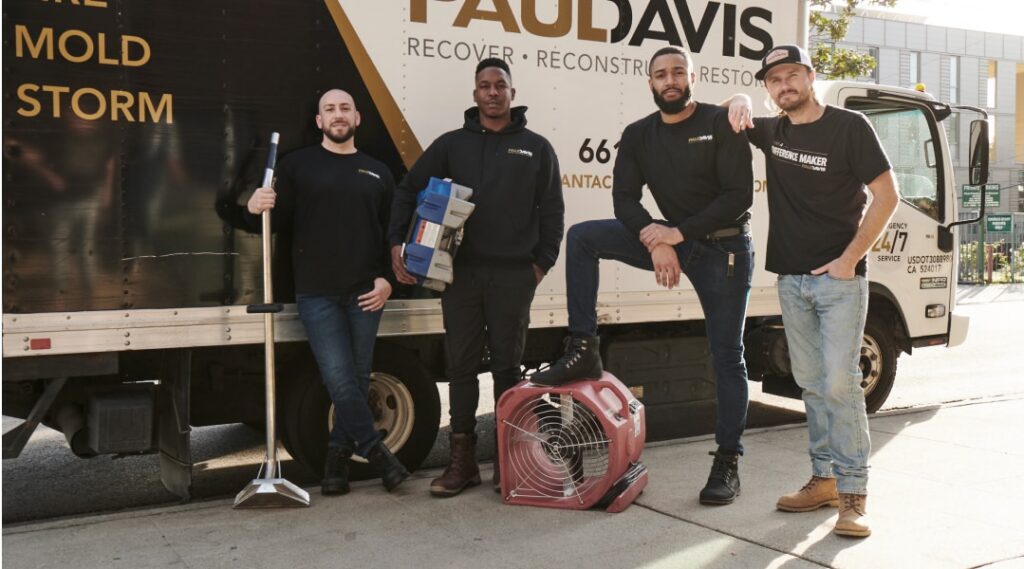 Paul Davis Restoration team in Idaho Falls, ID standing by service truck with water damage restoration equipment and drying fans, ready for 24/7 emergency cleanup and repair